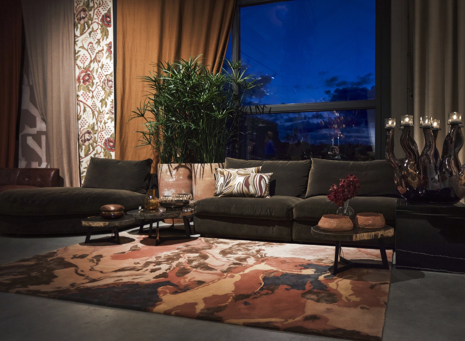 Vloerkleed in terra en roze tinten in een woonkamer bij avond